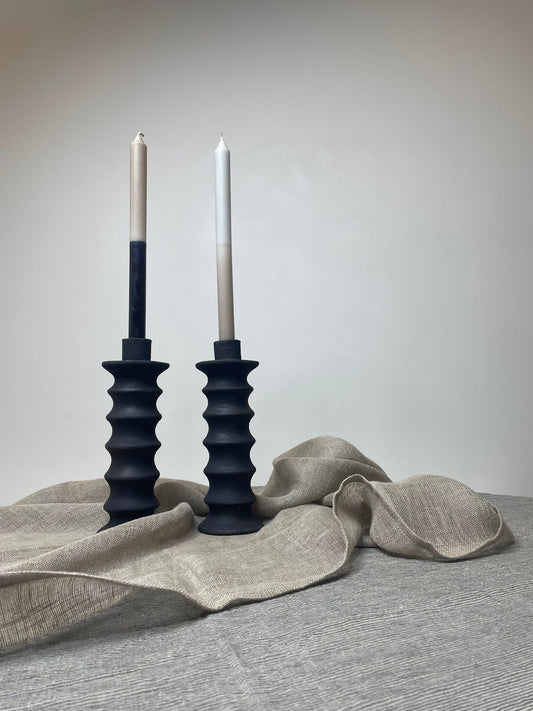 linen tablecloth and runner with two candles in candlesticks on top