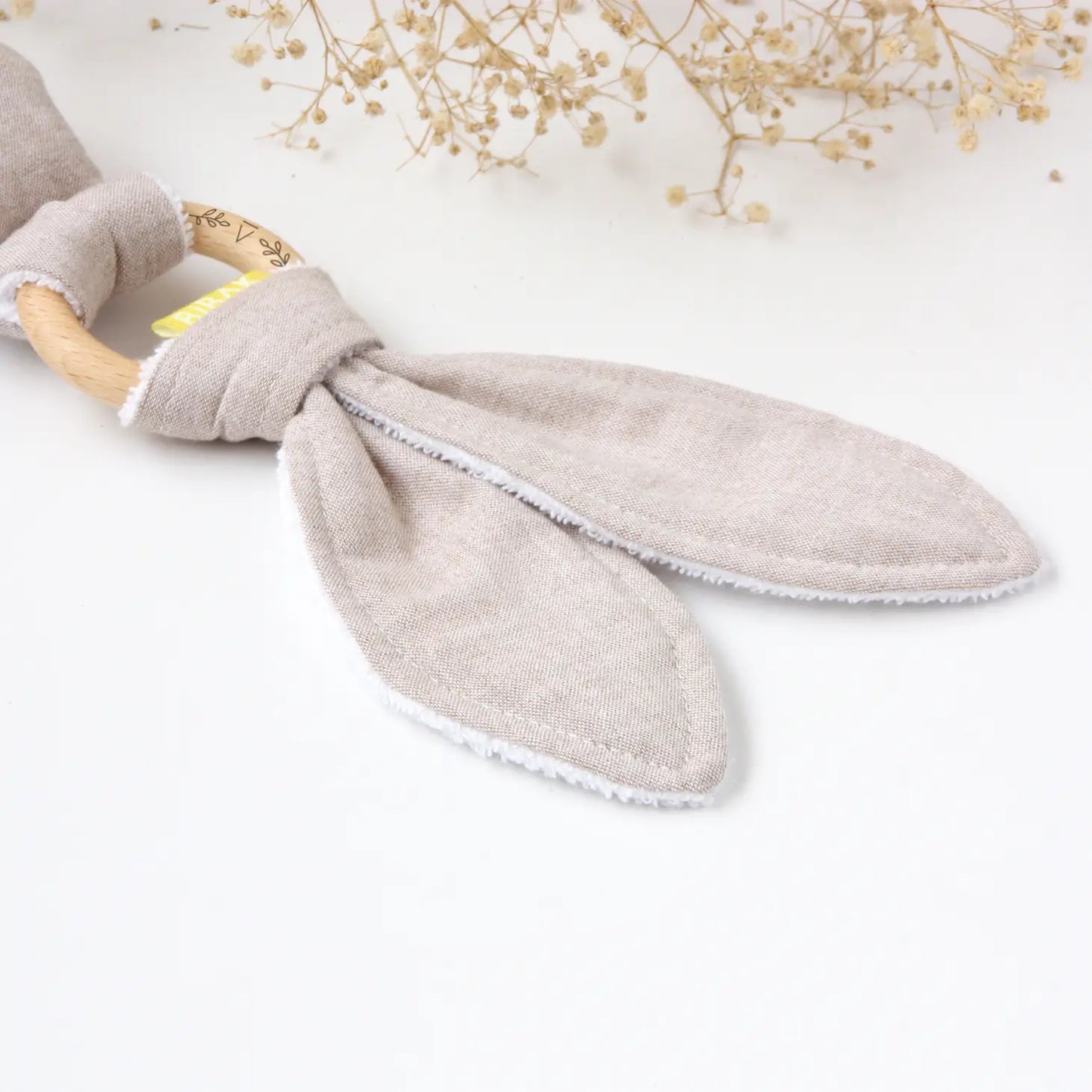close up of the ears on a greige rabbit rattle/teether