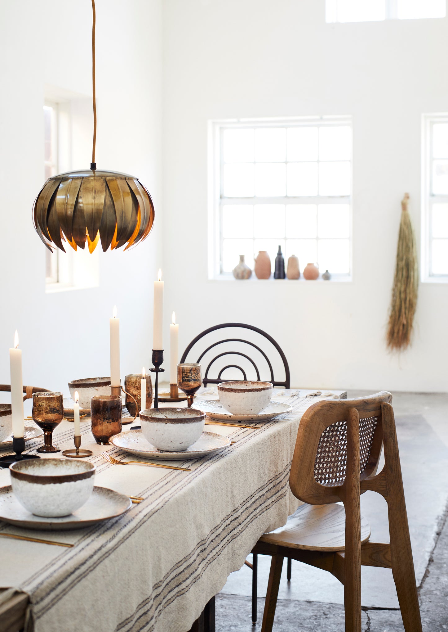 an indoor table setting with white and brown accents