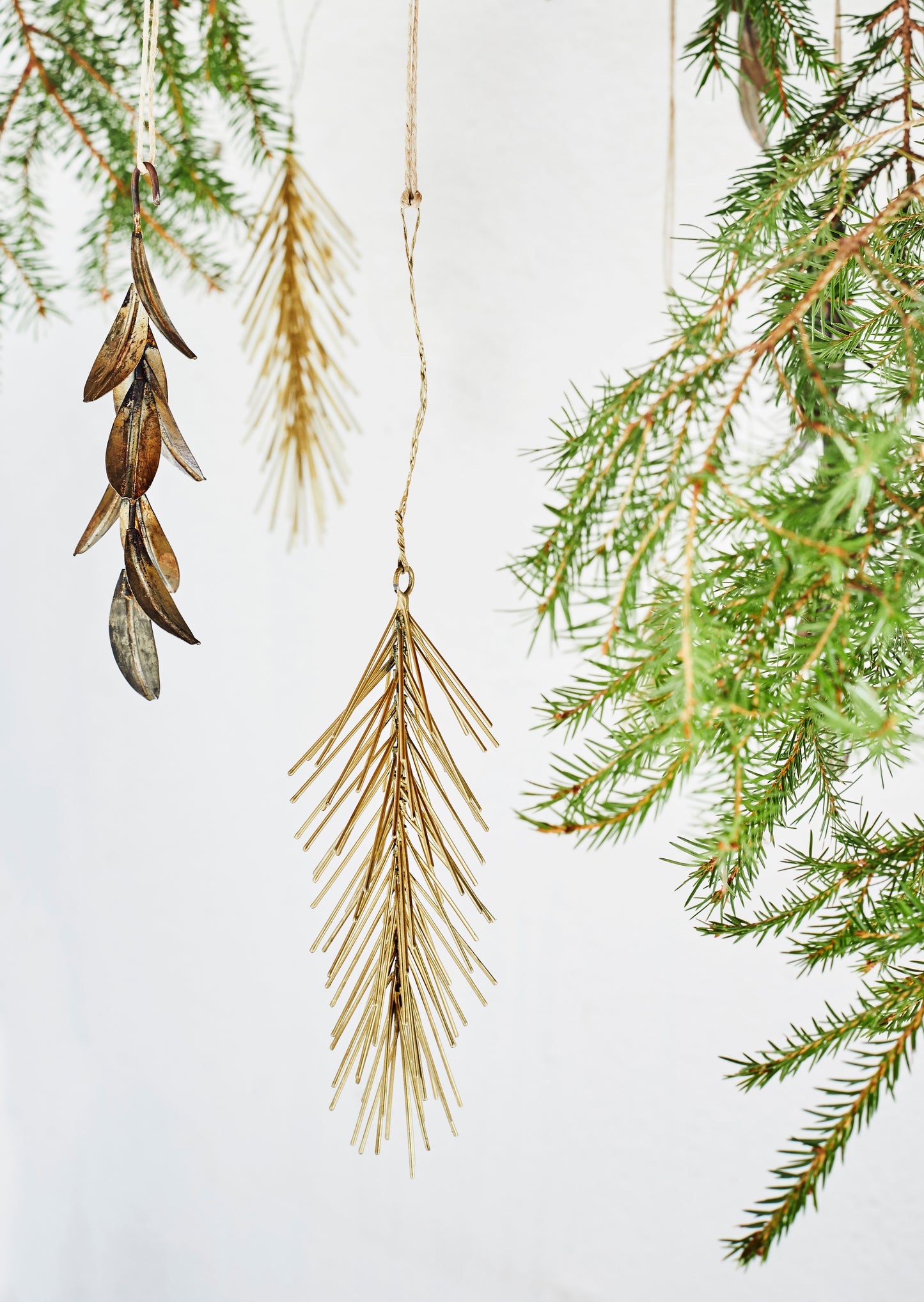 Close up of a Christmas tree with hanging spruce decorations made from iron