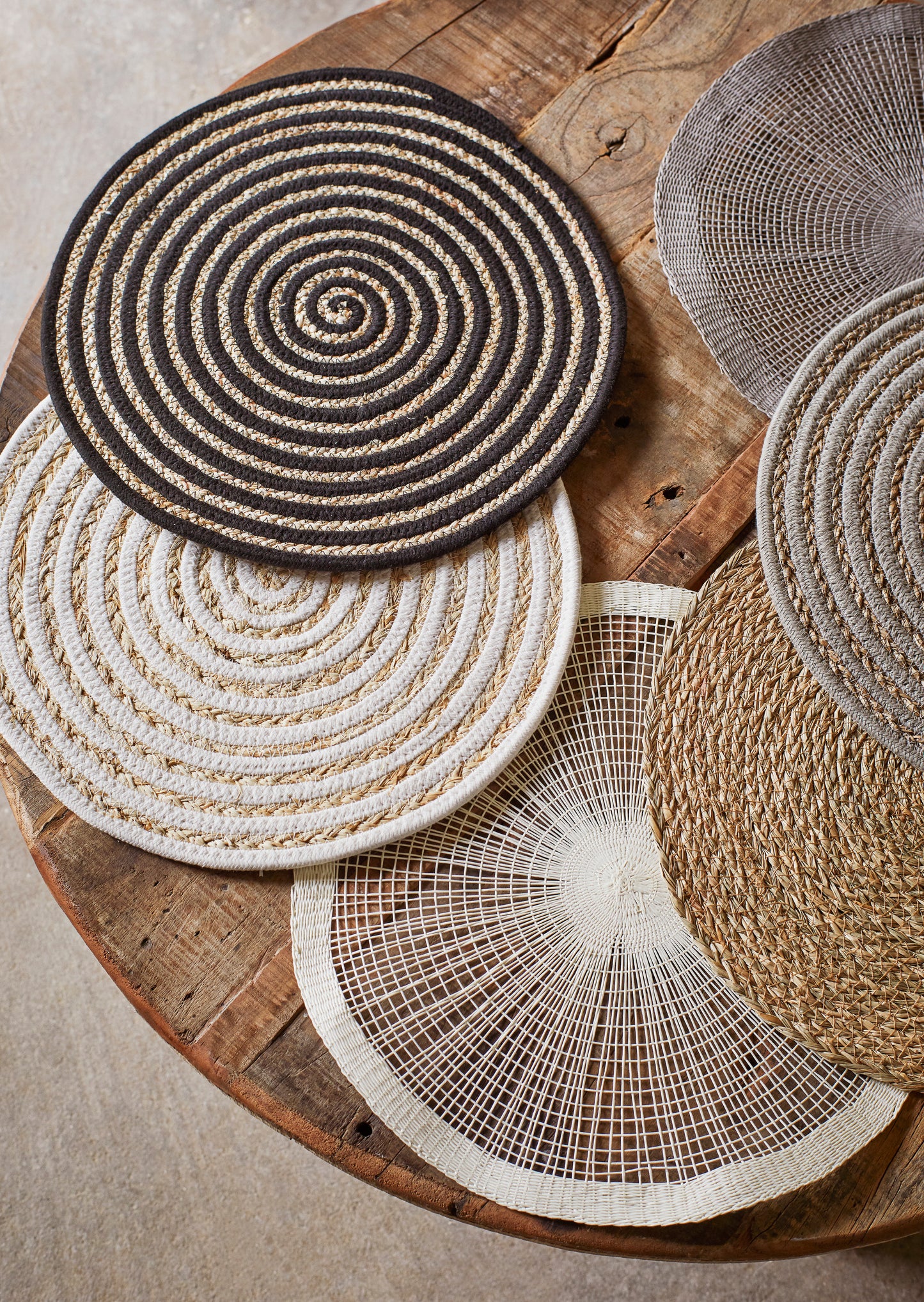 A selection of placemats on a wooden table