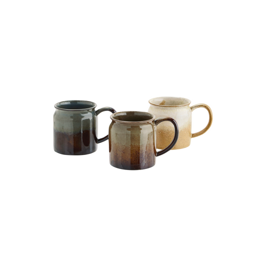 three stoneware mugs with handles in cream, brown and blue grey