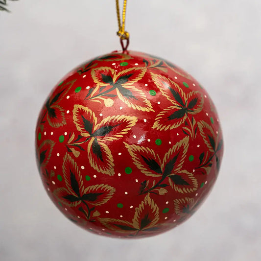 red bauble with hand-painted flowers in gold