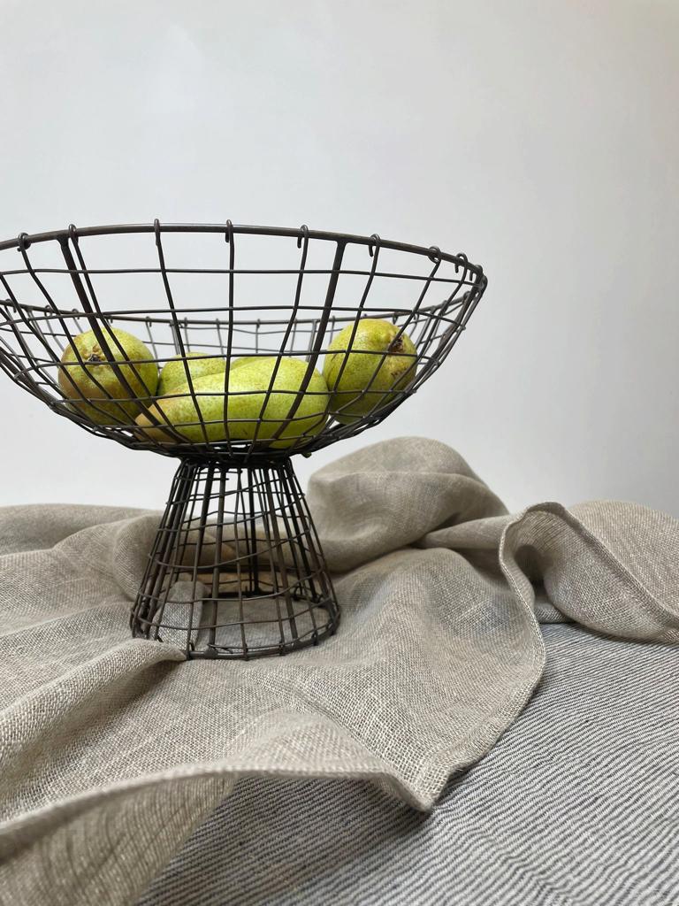 linen tablecloth and runner with metal wire fruit bowl on top
