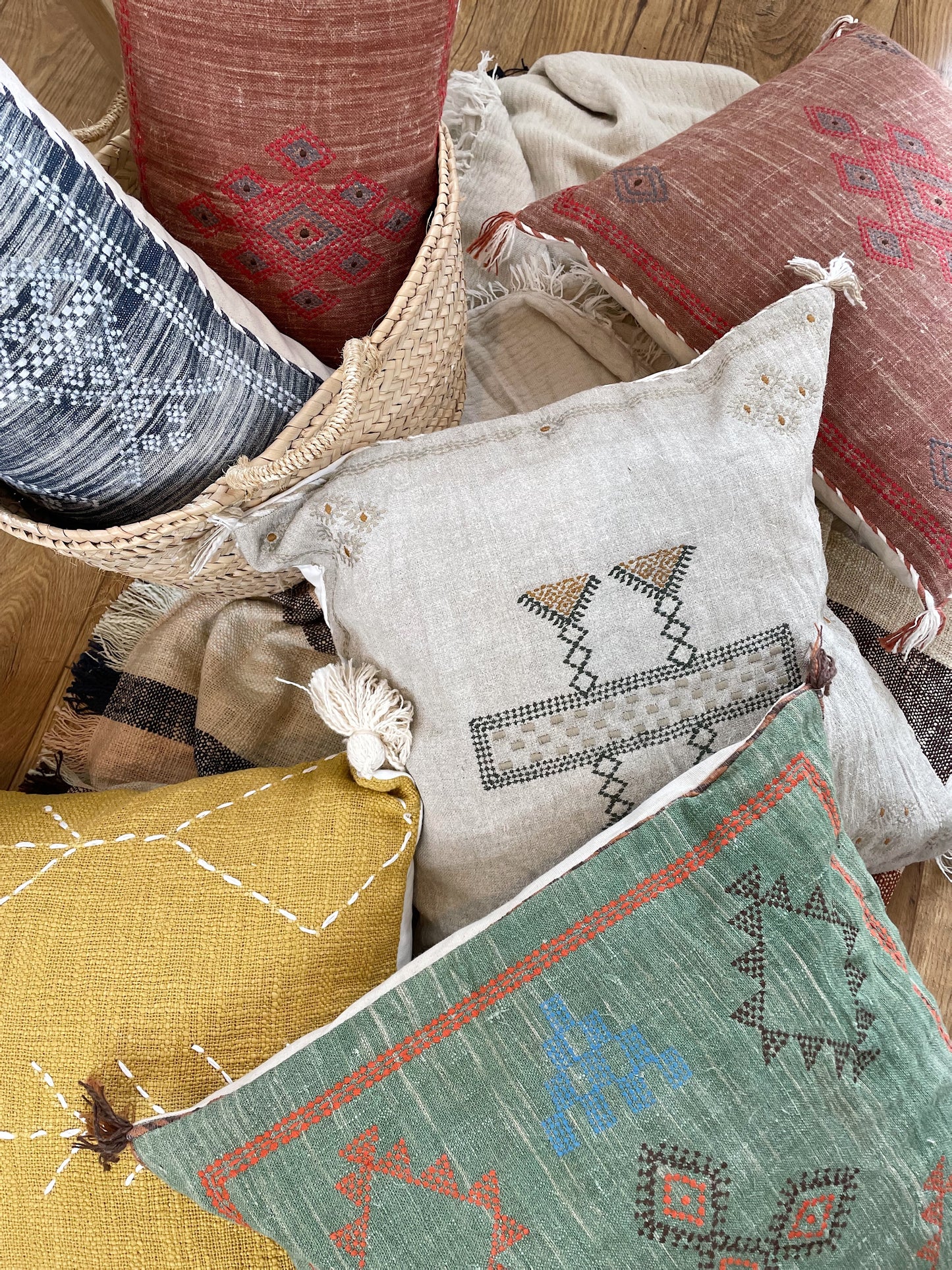 colourful cushions scattered on a floor