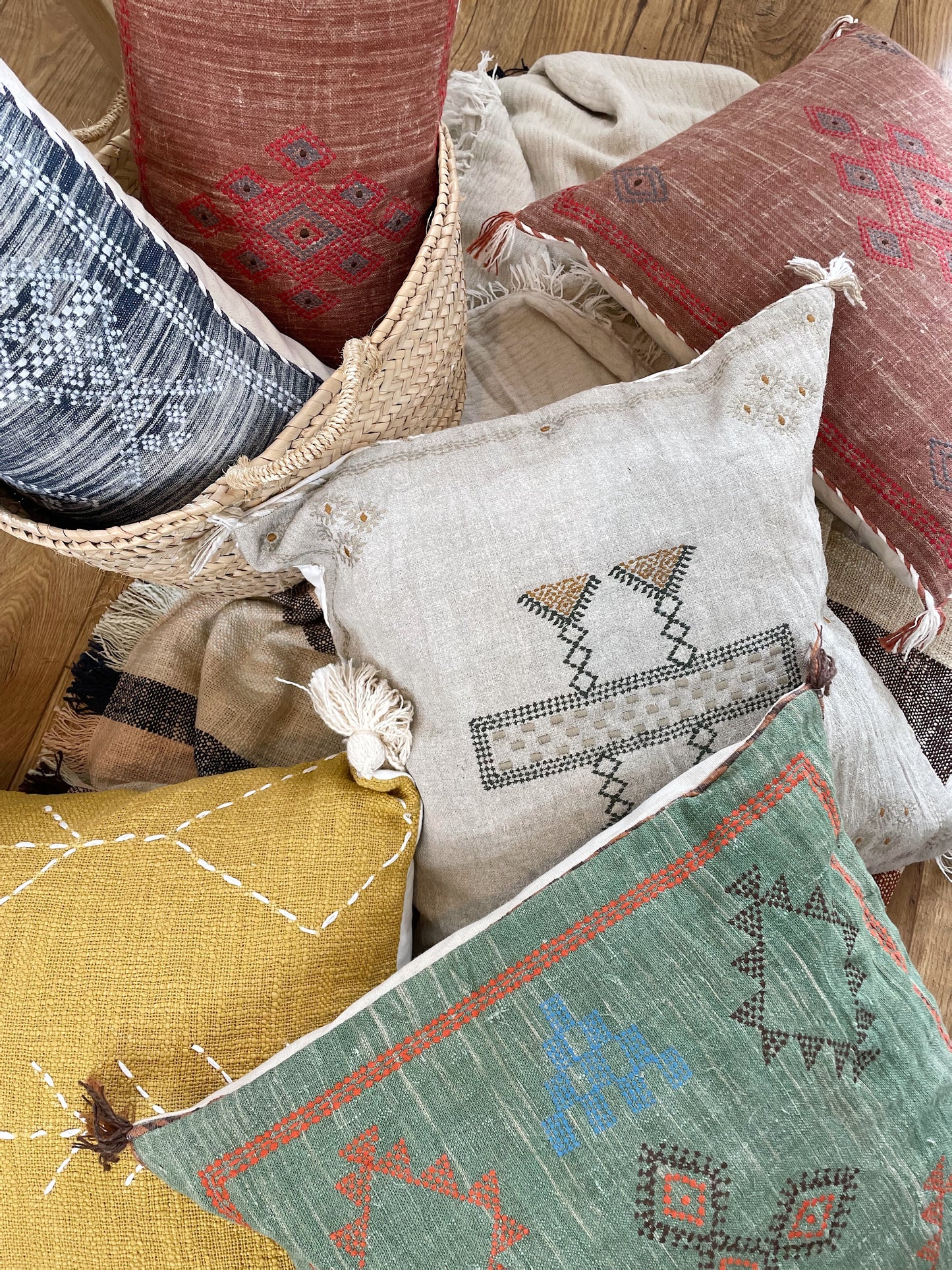 colourful cushions, scattered in a pile on the floor