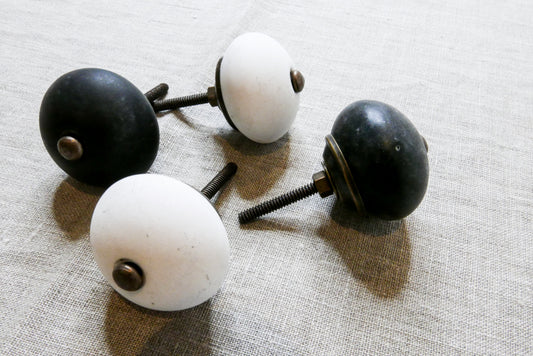two black and two white stoneware doorhandles / doorknobs 