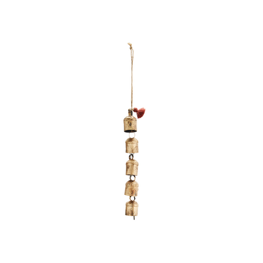 set of six iron bells hanging from a jute string, with a burnt orange tassel at the top