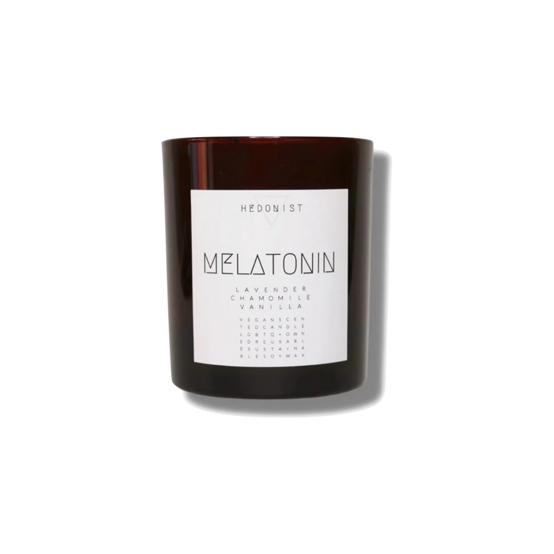 Candle housed in a brown glass jar, with a white label featuring simple text with the name Melatonin in caps
