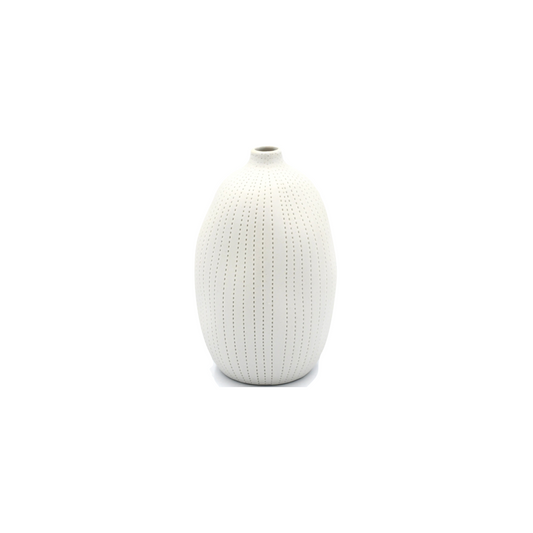 white bud vase with lines of small indents