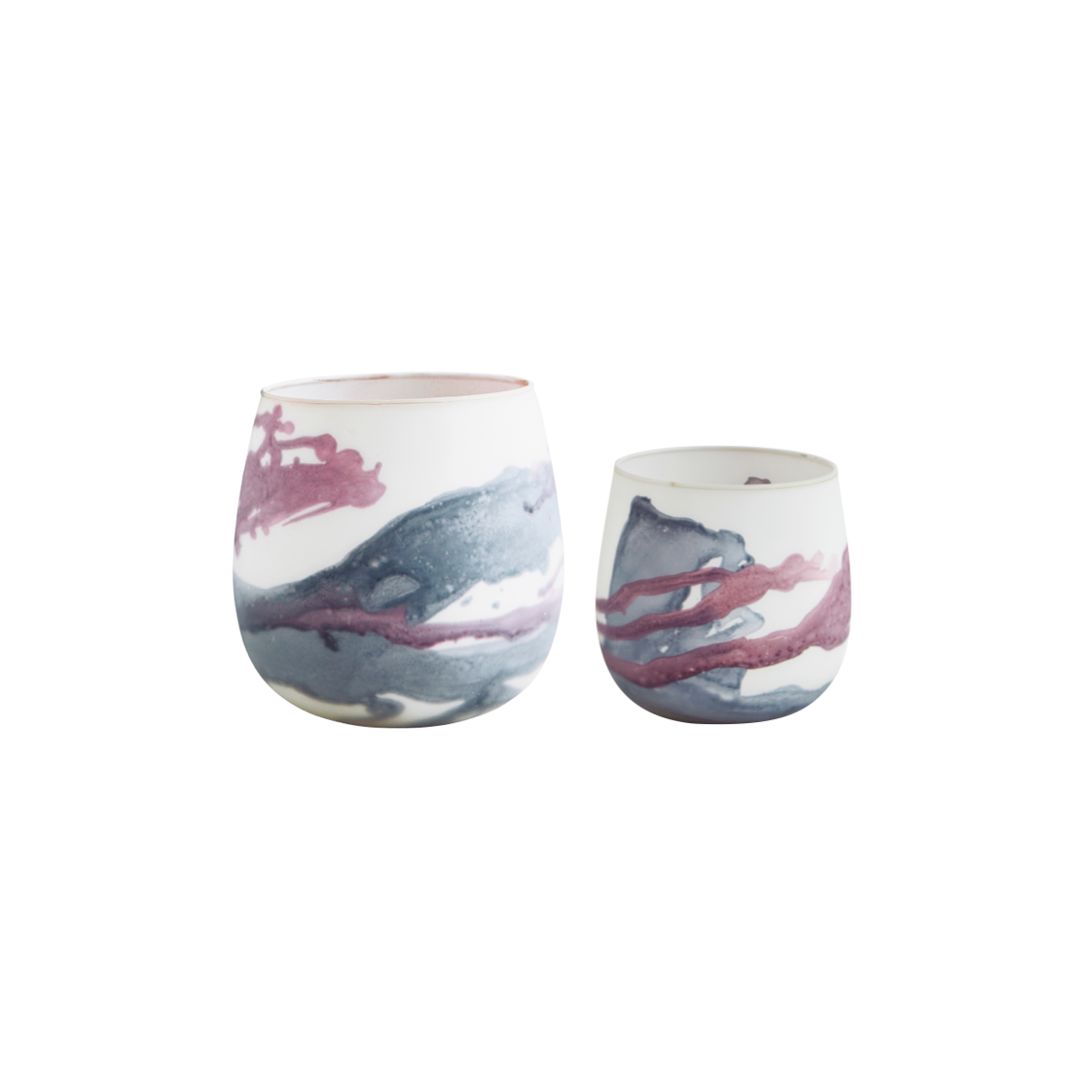 Set of two glass votives, one larger than the other, with a base colour of off white and paint splatters in grey and purple