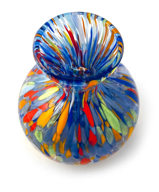 small blue glass vase with round bottom and fluted top, covered in colourful splatters of blue, red, green and orange